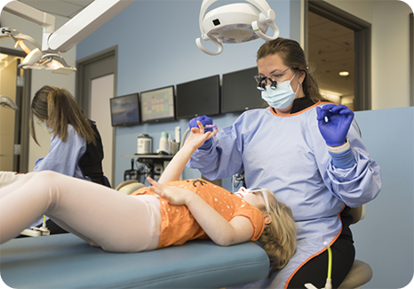 Two toddlers sitting on the floor playing with toys