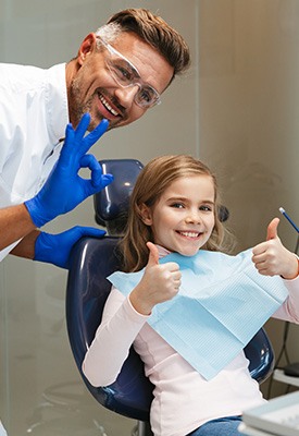 Girl giving thumbs up in the dental chair